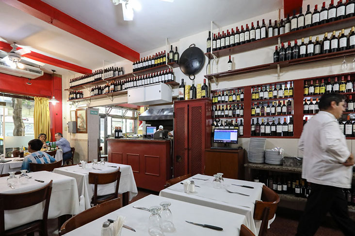Bottles of wine line the shelves at Parrilla Peña
