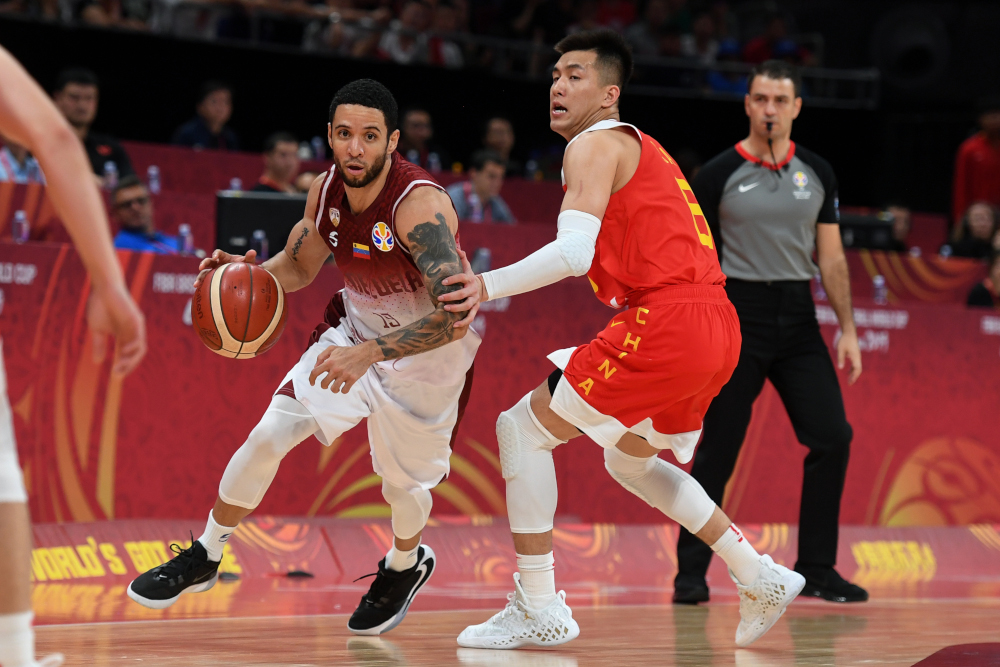 Venezuelau00e2u20acu2122s Heissler Guillent (left) runs with the ball past Chinau00e2u20acu2122s Guo Ailun during the Basketball World Cup Group A game between Venezuela and China in Beijing September 4, 2019. u00e2u20acu201d AFP pic 