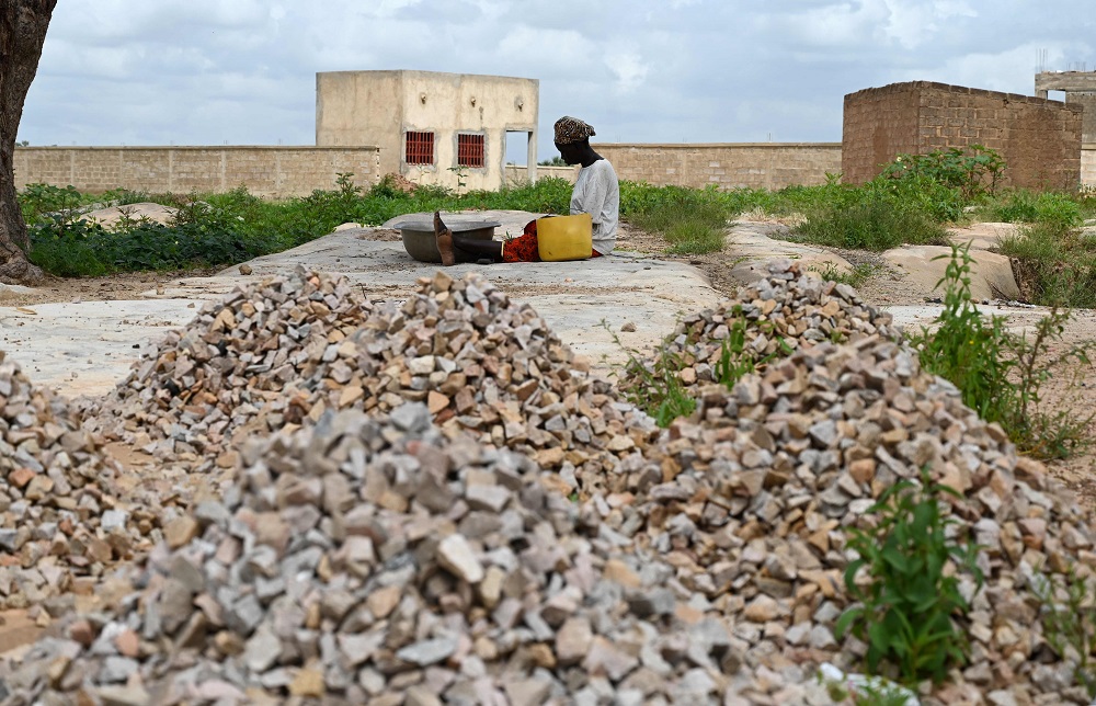 A woman, who is among the 300,000 internally displaced because of jihadist violence in northern and eastern Burkina Faso, sits on the ground between stones on September 17, 2019 in the village of Yagma near Ouagadougou. u00e2u20acu201d AFP pic        