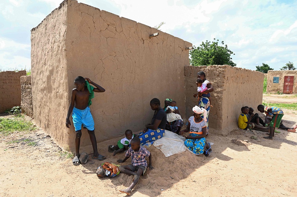Children sit in the shadow of a house in the village of Yagma, north of Ouagadougou, Burkina Faso September 17, 2019. — AFP pic