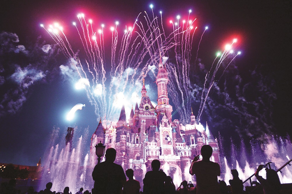 This photo taken on June 16, 2017 shows visitors watching fireworks exploding over the castle at an event to mark the first anniversary of the opening of Shanghai Disneyland in Shanghai. u00e2u20acu2022 STR/China Out/AFP pic