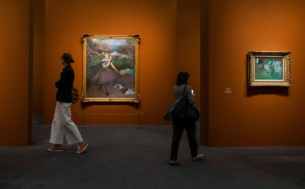 Visitors walk past the painting u00e2u20acu02dcDanseuse aux bouquetsu00e2u20acu2122, painted around 1885-1900 by French painter Edgar Degas, during the press visit of the exhibition u00e2u20acu02dcDegas at the Operau00e2u20acu2122 at the Museum of Orsay, in Paris September 20, 2019. u00e2u20acu201d AFP pic  