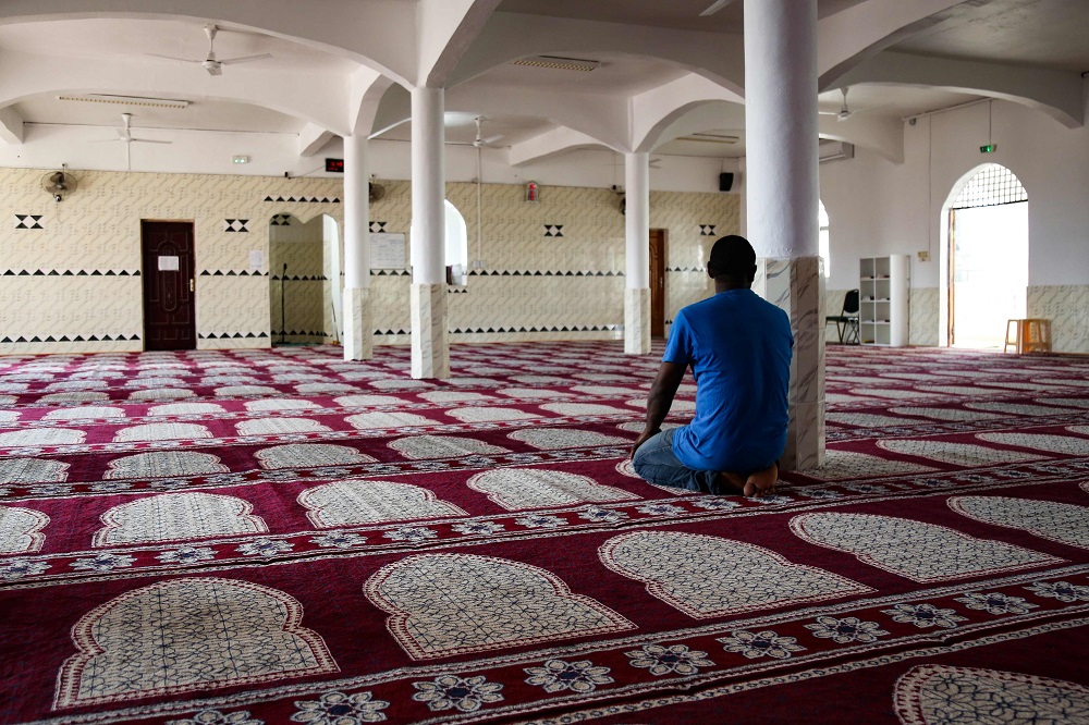 A man prays in a room of the mosque of Tsingoni, on the French island of Mayotte on September 14, 2019. — AFP pic