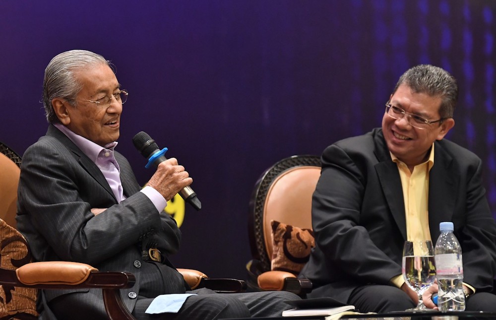 Foreign Minister Datuk Saifuddin Abdullah smiles as Prime Minister Tun Dr Mahathir Mohamad speaks during a dialogue in conjunction with a dinner for the Malaysian diaspora in Phnom Penh September 2, 2019. u00e2u20acu201d Bernama pic