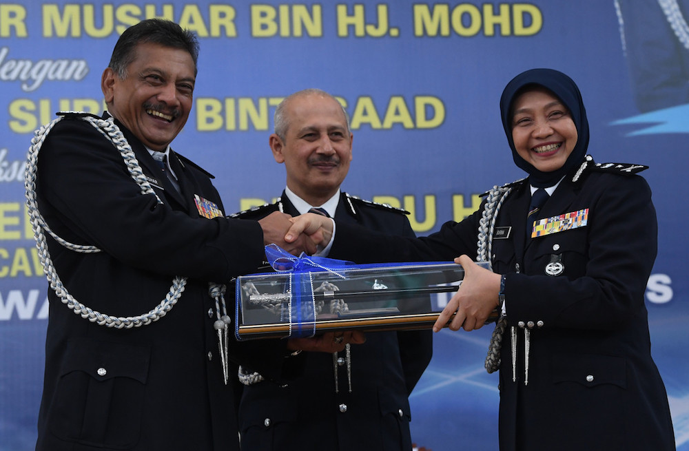 Datuk Surina Saad and Datuk Noor Mushar Mohamad participate in the handover ceremony at the Perlis police headquarters in Kangar September 3, 2019, as Bukit Aman Special Branch director Datuk Mohamed Farid Abu Hassan looks on. u00e2u20acu201d Bernama pic
