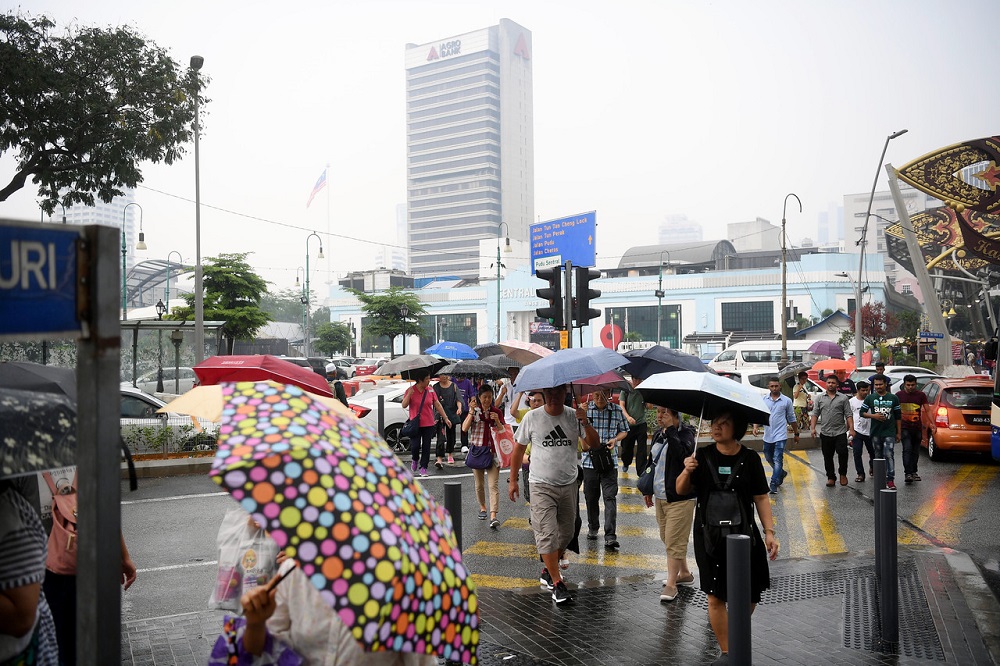 Pedestrians use umbrellas to shelter from the rain in Kuala Lumpur September 16, 2019. u00e2u20acu201d Bernama pic
