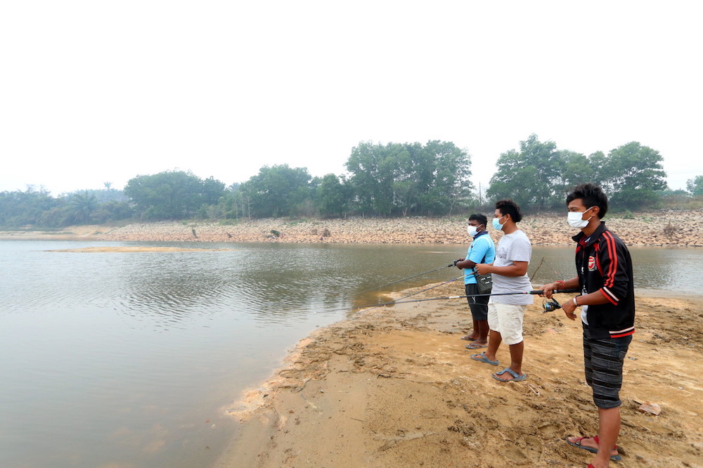 People fish in the middle of Jus Dam in Melaka September 17, 2019 due to the low water level. u00e2u20acu201d Bernama pic
