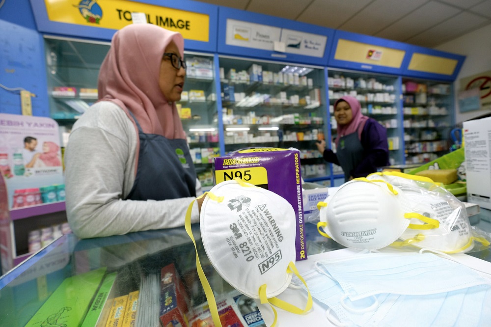 A pharmacy assistant arranges N95 face masks in a drugstore in Manjung September 18, 2019. u00e2u20acu201d Bernama pic