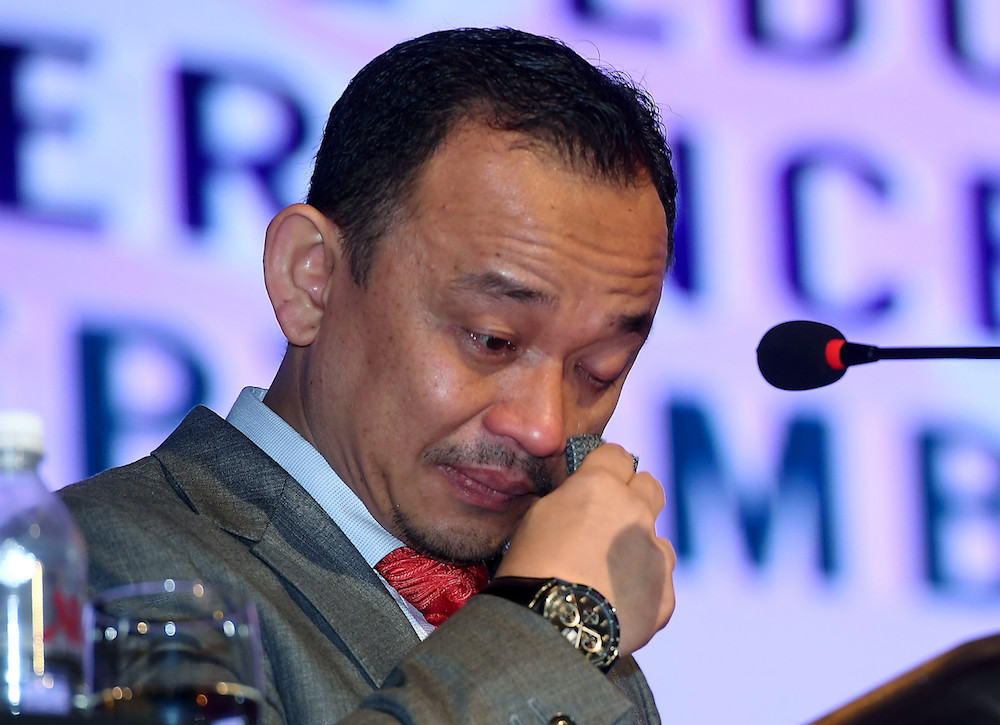 Education Minister Maszlee Malik dabs his eyes with a handkerchief during his speech at the Special Education International Conference in Putrajaya September 27, 2019. u00e2u20acu201d Bernama pic