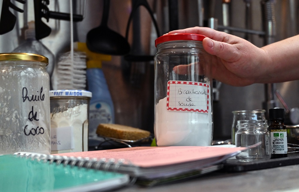 Magdalene Deleporte shows a glass of baking soda as she explains how she manufactures deodorant, in Roubaix, northern France. u00e2u20acu201d AFP pic