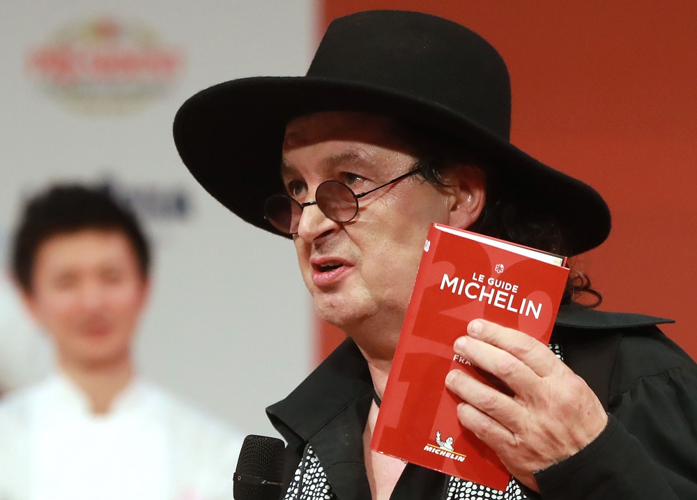 In this file photo taken on February 5, 2018, French chef Marc Veyrat, holds a Michelin guide after being awarded the maximum three stars, during the Michelin guide award ceremony at La Seine Musicale in Boulogne-Billancourt, near Paris. u00e2u20acu201d AFP pic  