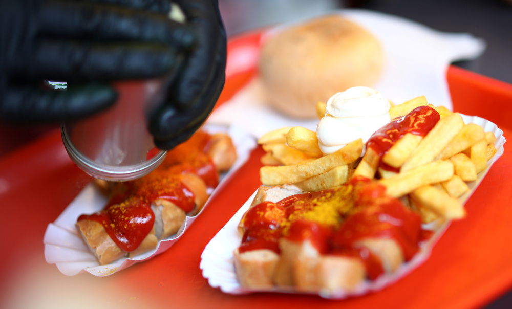 An employee of the famous snack bar ‘Konnopke’s Imbiss’ prepares typical German Currywurst (curried sausage) in Berlin, Germany, September 3, 2019. — Reuters pic