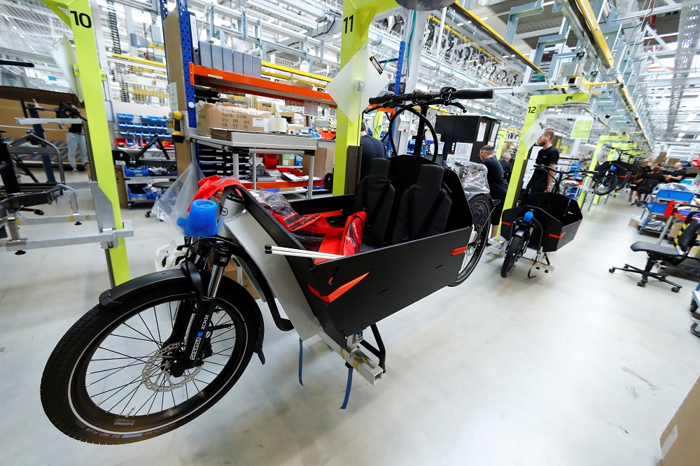 Employees work on electric cargo bicycles at the production plant of e-bike manufacturer Riese & Mueller in Muehltal near Darmstadt, Germany August 30, 2019. — Reuters pic