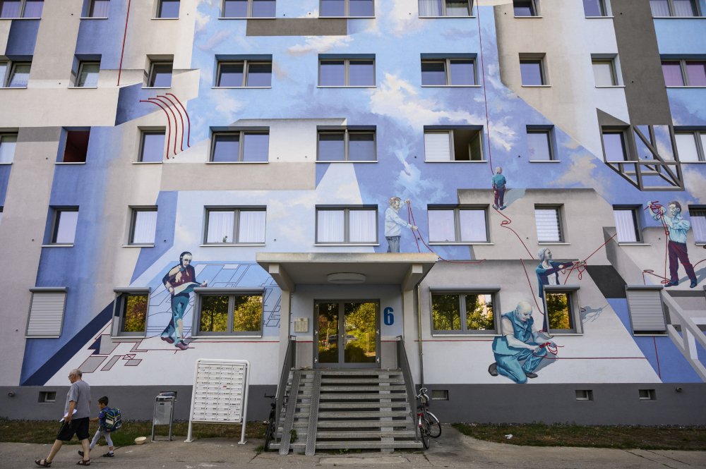 A giant mural by the urban art collective u00e2u20acu02dcFreiraumgalerieu00e2u20acu2122, which features likenesses of real people, decorates a residential building owned by the HWG housing company in Halle. u00e2u20acu201d AFP pic