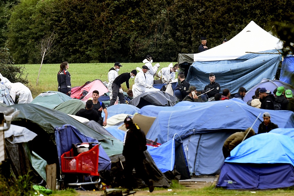 People leave the Grande Synthe migrant camp during its evacuation by French gendarmes in Grande-Synthe, northern France September 17, 2019. u00e2u20acu201d AFP pic          