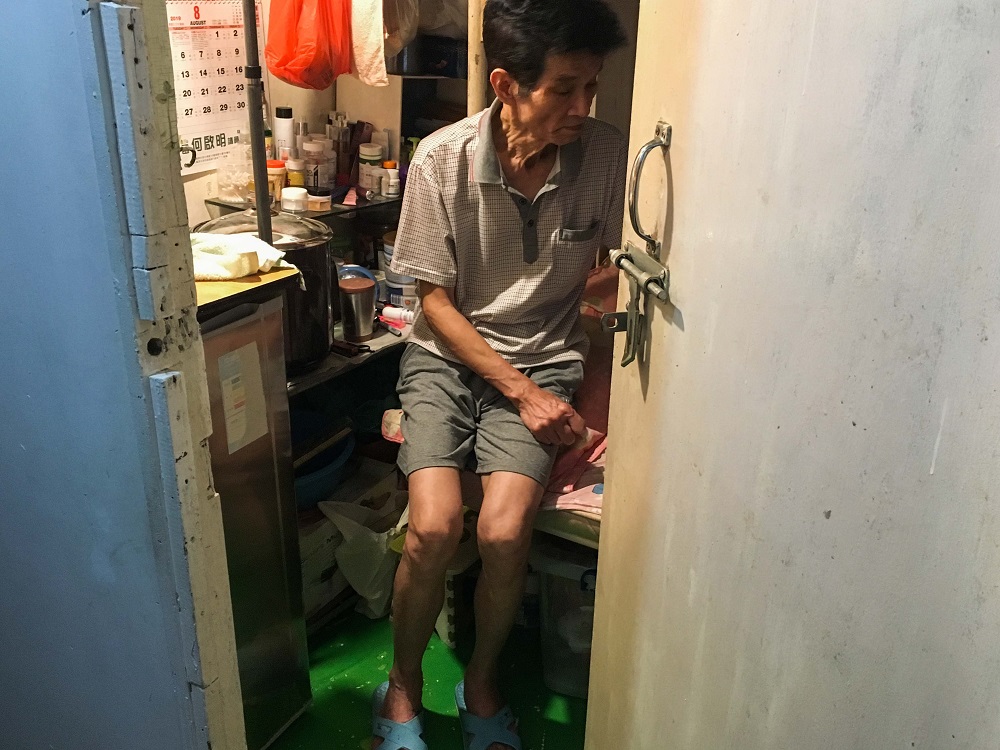 Luk Chin Tak sits in his room that he shares with his wife in a sub-divided apartment with six other residents in Kowloon, Hong Kong, ranked as the worldu00e2u20acu2122s least affordable housing market August 8, 2019. u00e2u20acu201d Thomson Reuters Foundation pic