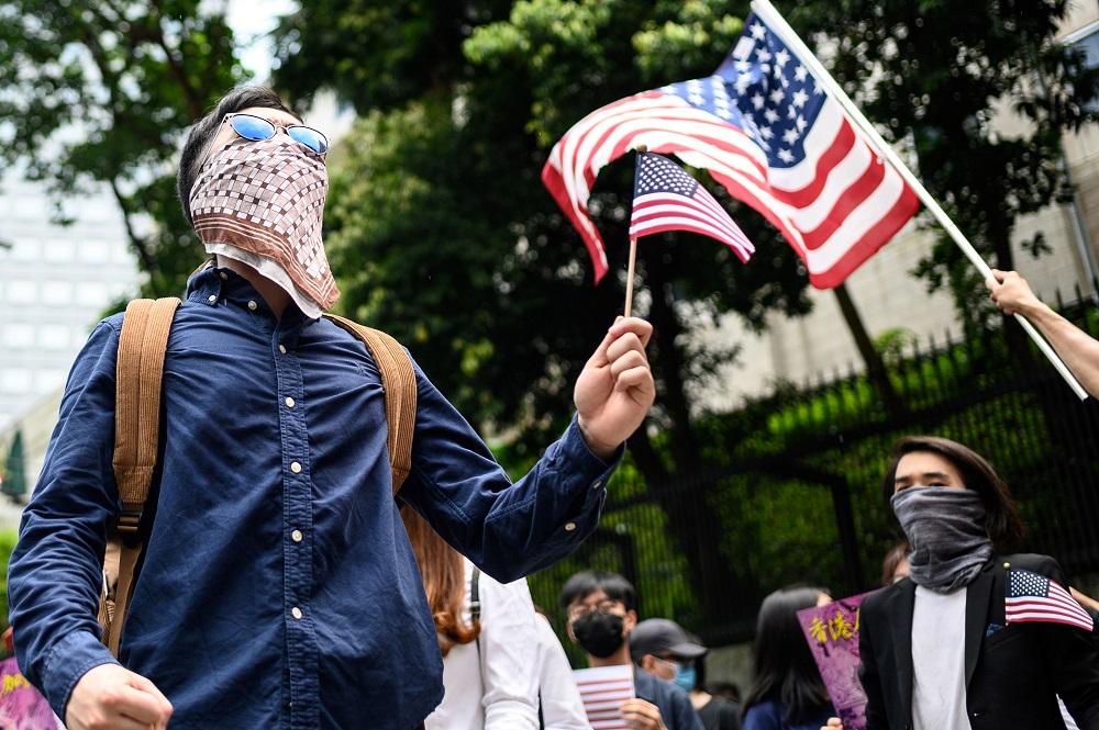 This picture taken on September 8, 2019 shows recent Hong Kong protester ‘Chris’ (left) taking part in a rally and march to the US Consulate in Hong Kong. — AFP pic         