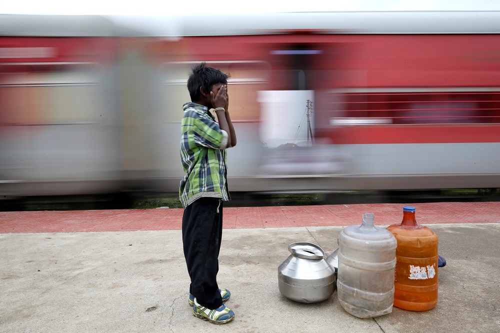 Siddharth Dhage, 10, waits to board a train with empty water containers, at Mukundwadi railway station, Aurangabad, India July 20, 2019. u00e2u20acu201d Reuters pic