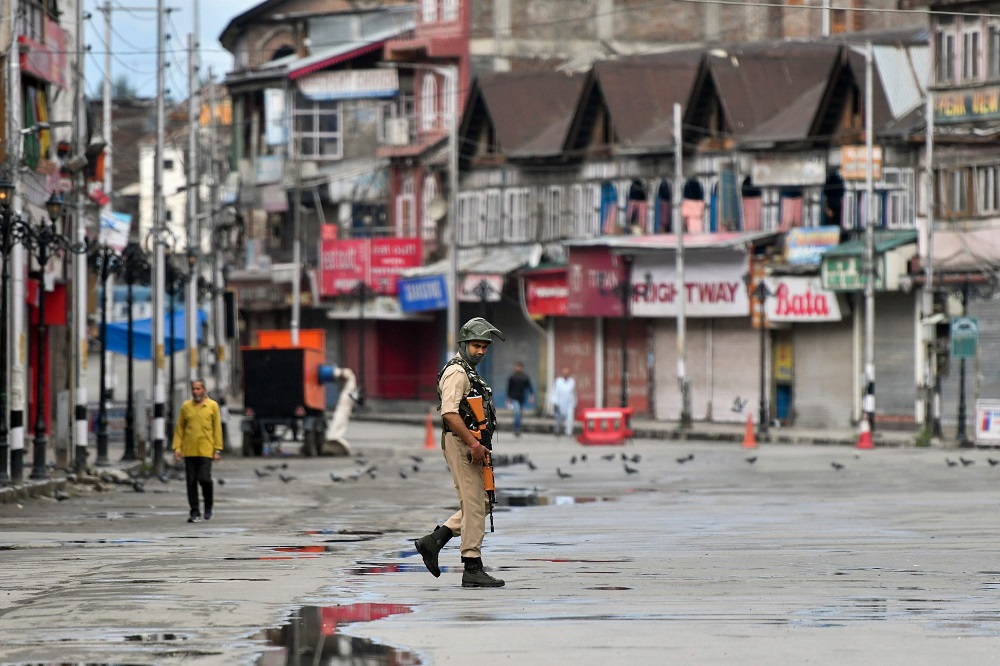 In this file photo taken on August 19, 2019, a security personnel patrols on a deserted road of the Lal Chowk area in Srinagar. — AFP pic