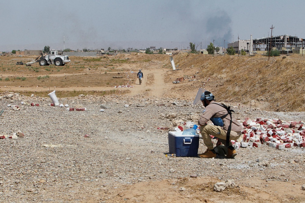 Iraqi mine clearers working for Halo Trust, a non-profit organisation specialised in mine removal, scan agricultural and industrial fields on August 25 near Iraqu00e2u20acu2122s Baiji. u00e2u20acu201d AFP pic          
