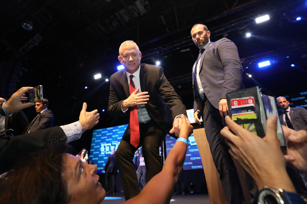 Benny Gantz, leader and candidate of the Israel Resilience party that is part of the Blue and White political alliance, shakes hands with supporters from the podium at the allianceu00e2u20acu2122s campaign headquarters in Tel Aviv September 18, 2019. u00e2u20acu201d AFP pic 