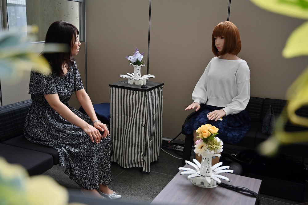 This photo taken on June 16, 2019 shows an assistant (left) for robotician Hiroshi Ishiguro u00e2u20acu02dctalkingu00e2u20acu2122 with a robot at the research centre in Osaka. u00e2u20acu201d AFP pic       