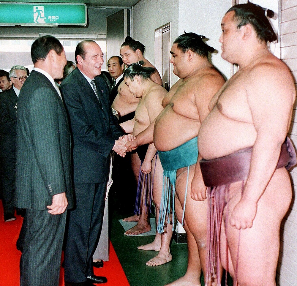 In this file photo taken on November 12, 1996 visiting French President and sumo-phile Jacques Chirac (second from left) is greeted by Sumo Wrestlers before their matches of the Kyushu Grand Sumo Tournament in Fukuoka, western Japan. u00e2u20acu201d AFP pic    