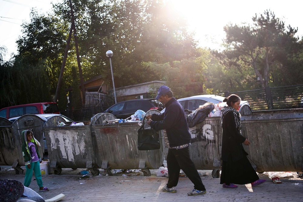 Bujar Maksuti and his wife search waste in the containers in Pristina, Kosovo September 10, 2019. — AFP pic