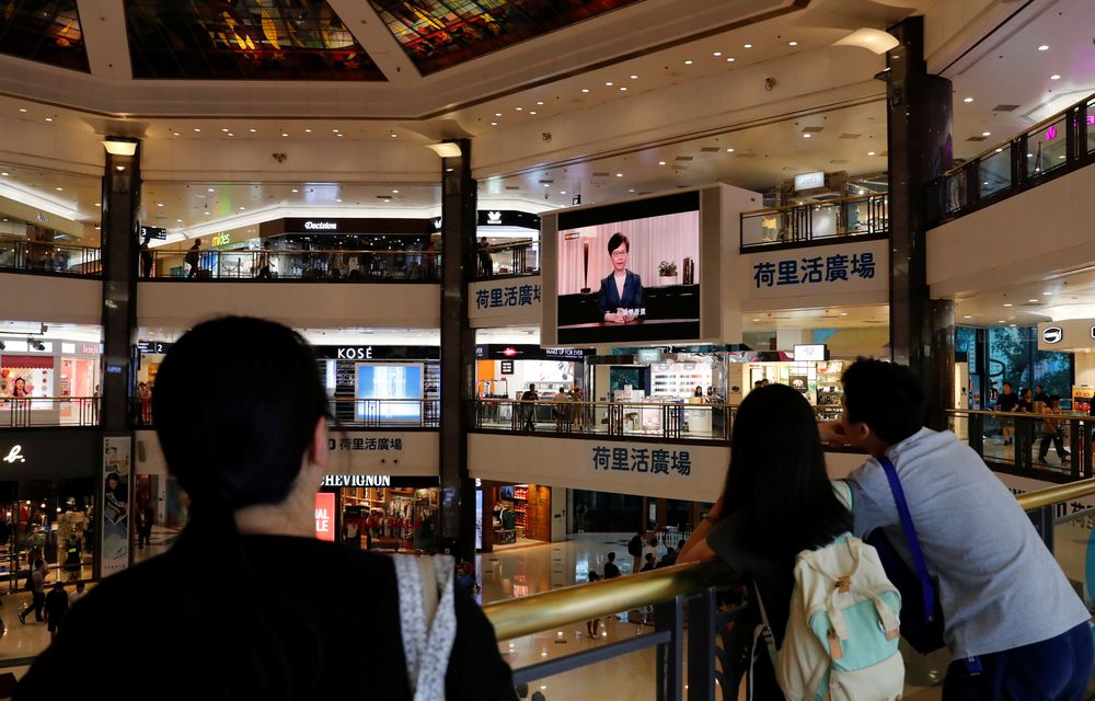 People watch a news conference of Hong Kongu00e2u20acu2122s Chief Executive Carrie Lam televised on a big screen in a shopping mall in Hong Kong, China, September 4, 2019.  u00e2u20acu201d Reuters pic