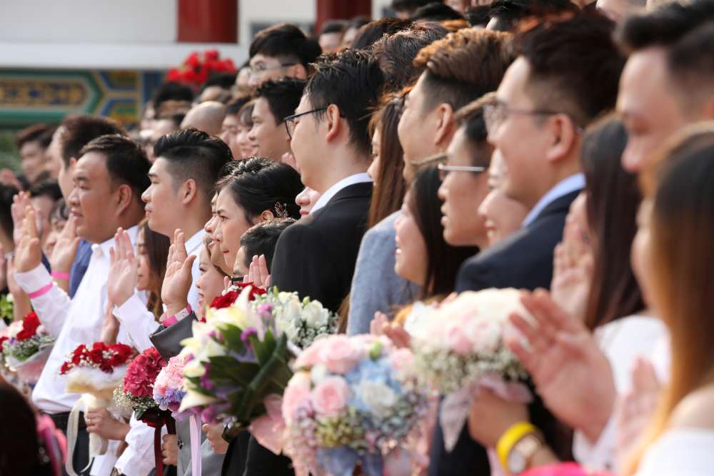 Newlywed couples take their vows during a mass wedding at a Chinese temple in Kuala Lumpur September 9, 2019. ― Reuters pic
