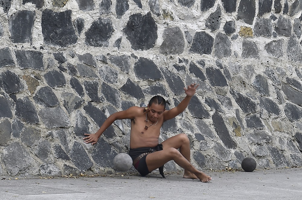 A man plays a pre-Columbian ballgame called ‘Ulama’ — in Nahuatl indigenous language — which rule is to hit a ‘Ulamaloni’ (solid rubber ball) with the hip or shoulder, during a match at the FARO Poniente cultural centre in Mexico City August 21, 2019. — AFP pic         