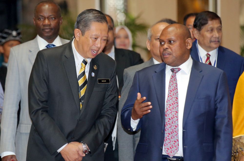 Uganda Lands, Housing and Urban Development Minister Isaac Musumba and Datuk Seri Mohammad Nizar Jamaluddin (left) speak during the Perak-Uganda Trade Gateway Forum held at Impiana Hotel, Ipoh September 4, 2019. u00e2u20acu201d Picture by Farhan Najib