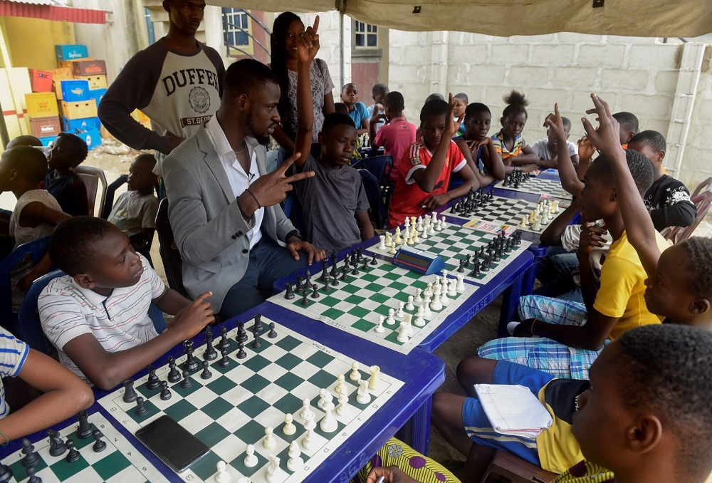 Chess consultant and player Tunde Onakoya (centre) gestures as he addresses children during a chess class at Ogolonto in Ikorodu district of Lagos August 17, 2019. u00e2u20acu201d AFP pic
