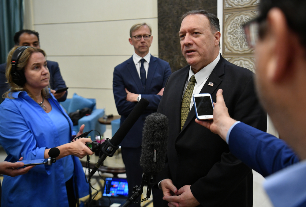 US special representative on Iran Brian Hook (background) listens as US Secretary of State Mike Pompeo speaks to reporters before departing from al-Bateen Air Base in Abu Dhabi September 19, 2019. u00e2u20acu201d AFP pic