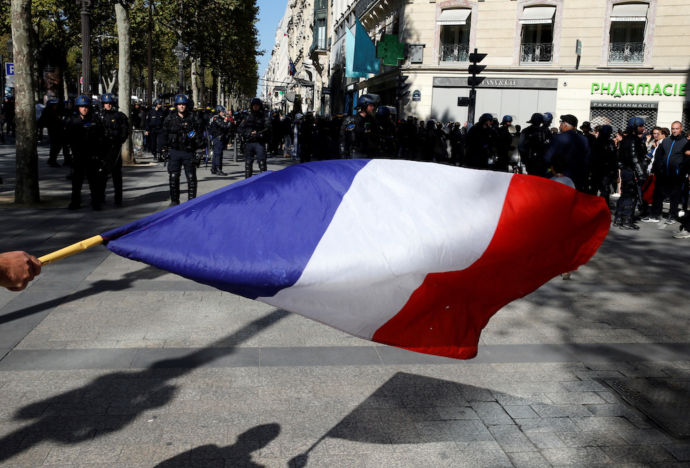 A person holds a French flag as he takes part in a demonstration on Act 45 (the 45th consecutive national protest on Saturday) of the yellow vests movement in Paris, France, September 21, 2019. u00e2u20acu201d Reuters pic