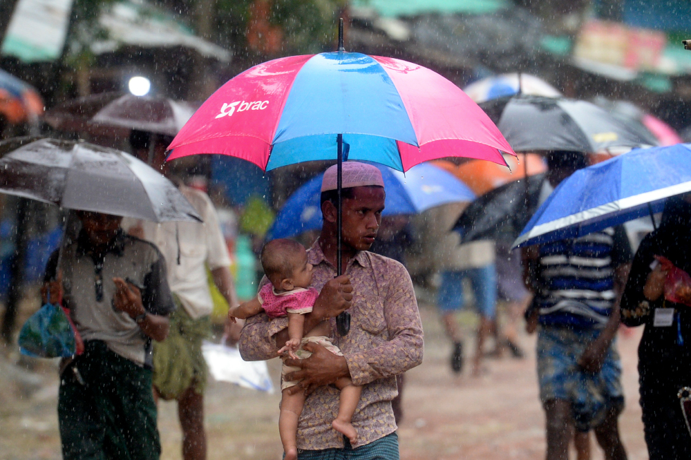 Rohingya refugees make their way during a monsoon rainfall at Kutupalong refugee camp in Ukhia September 12, 2019. u00e2u20acu201d AFP pic 