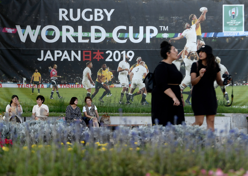 People walk past a banner promoting the upcoming Japan 2019 Rugby World Cup in Kobe September 17, 2019. u00e2u20acu201d AFP pic