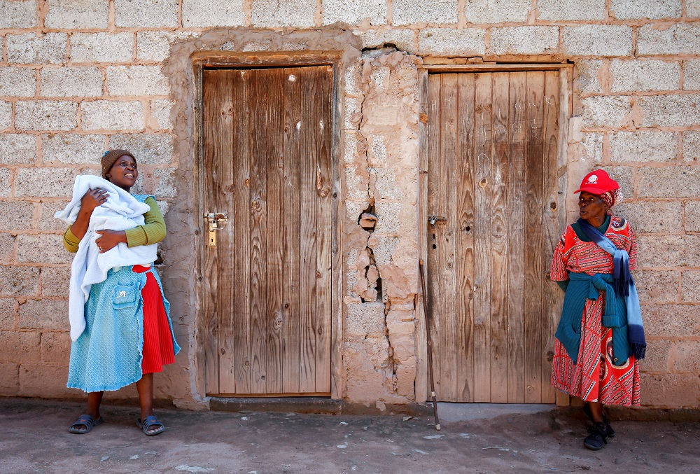 Fikhile Mthiyane (left), holds her 2-week-old grandson Lubanzi Ndlovu as she talks with her mother-in law, Thumekile Mthiyane, 90, who is known as Gogo Mthiyane, outside of the family home in KwaNdengezi, South Africa May 18, 2017. u00e2u20acu201d Reuters pic