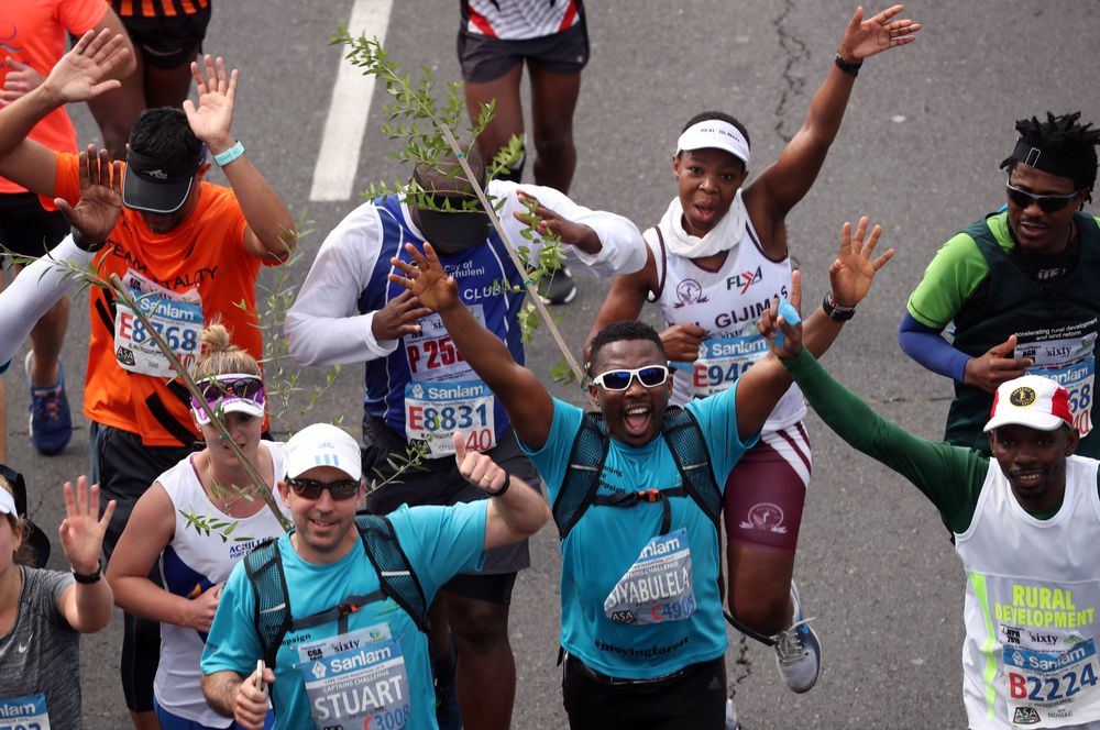 Activist Siyabulela Sokomani celebrates as he approaches the final stretch of the Cape Town marathon, in South Africa September 15, 2019. He is one of a group of 20 runners participating in the marathon with saplings on their backs. u00e2u20acu201d Reuters pic