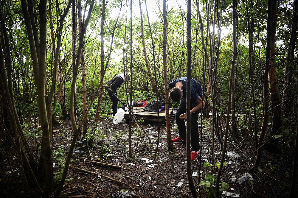 Drug addict Michael (right) is seen preparing to inject cocaine in a small wooded area used by addicts to take drugs near Glasgow city centre, Scotland August 15, 2019. — AFP pic