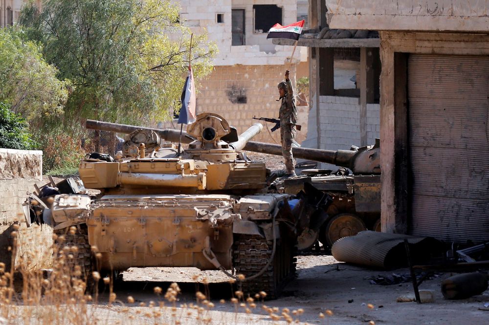 A Syrian army soldier holds a Syrian flag as he stands on a military vehicle in Khan Sheikhoun, Idlib, Syria, August 24, 2019. u00e2u20acu201d Reuters pic
