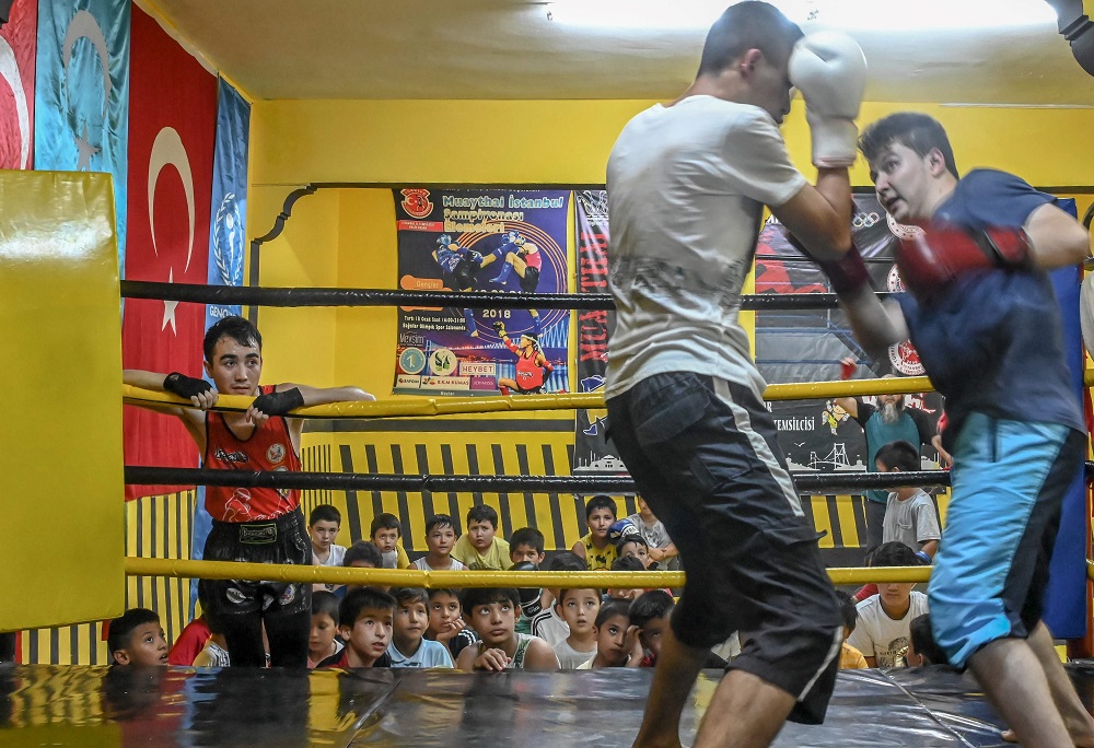 In this photograph taken on August 29, 2019, boxers take part in a training match as children from muslim Uighur minority watch in a boxing academy in Istanbul. u00e2u20acu201d AFP pic  