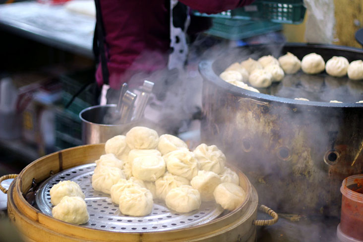 Bamboo steamers filled with 'shuǐ jiān bāo' or leek stuffed dumplings