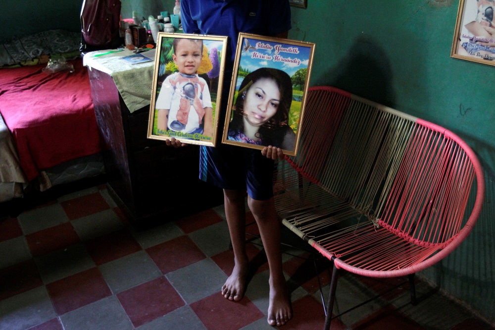 Martin Hernandez, brother of late Honduran migrant Idalia Yamileth holds framed pictures of his late sister and nephew at her home in El Limon, Nacaome, Honduras September 19, 2019. u00e2u20acu201d Reuters pic
