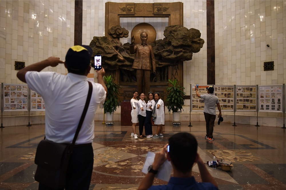 Tourists posing for a photograph in front of a statue of Vietnamu00e2u20acu2122s revolutionary leader Ho Chi Minh, at the Ho Chi Minh museum in Hanoi August 28, 2019. u00e2u20acu201d AFP pic