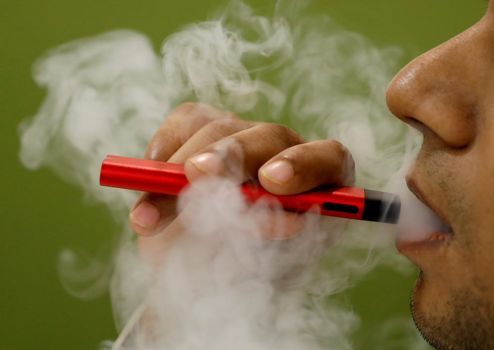 A man uses a vape device in this illustration picture, September 19, 2019. u00e2u20acu201d Reuters pic