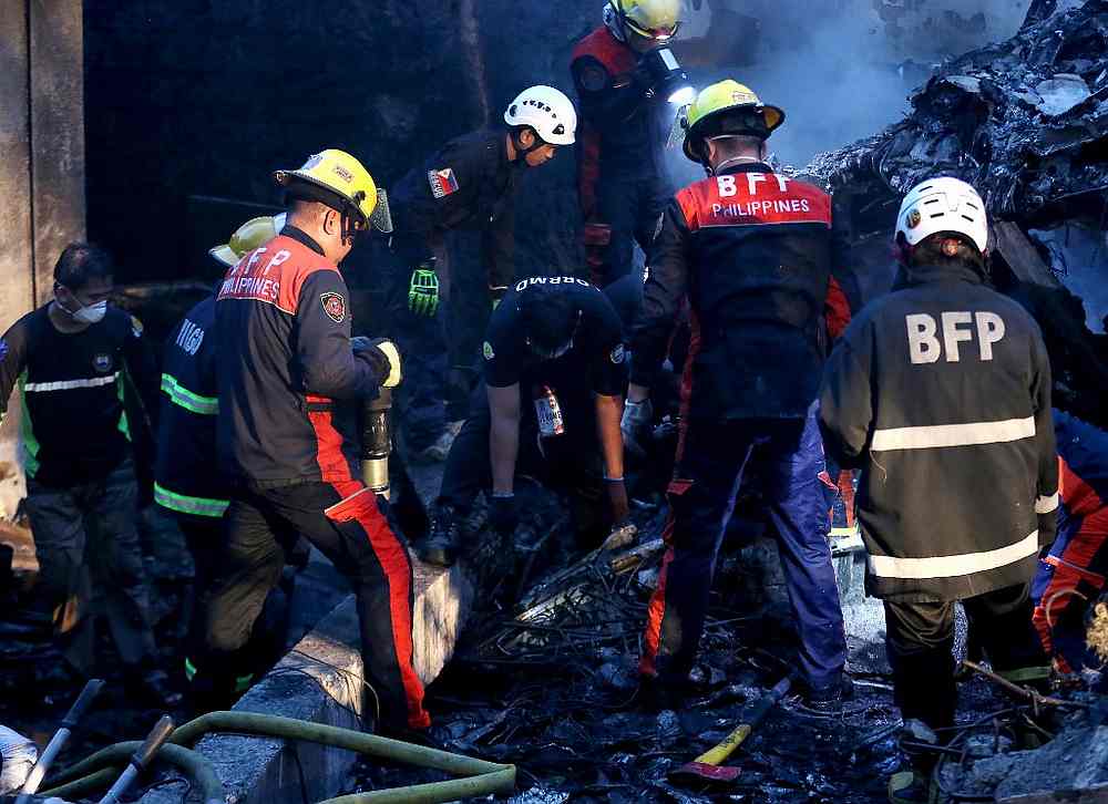 Firefighters sift through the site looking for bodies of passengers of a air-ambulance plane that crashed into a resort area in Calamba City, Laguna province, south of Manila September 1, 2019. u00e2u20acu201d AFP pic