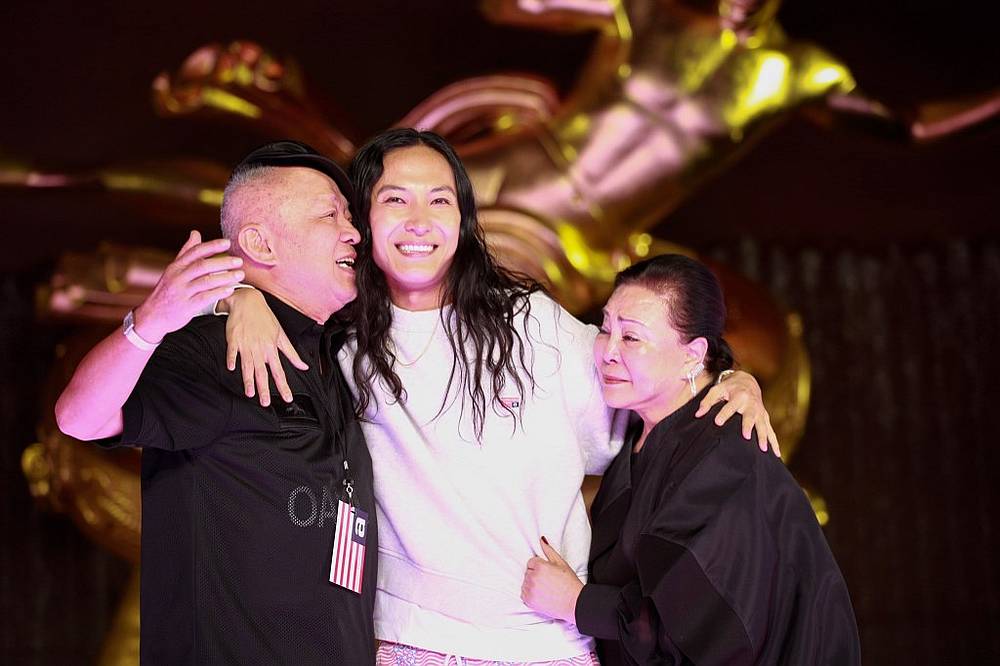 Fashion designer Alexander Wang (centre) reacts with his parents after his fashion show at the Rockefeller Center in New York May 31, 2019. u00e2u20acu201d AFP pic