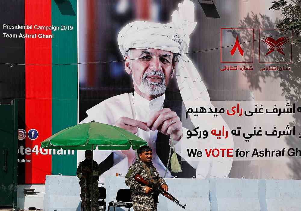A member of the Afghan security force stands in front of a poster of Afghan presidential candidate Ashraf Ghani in Kabul, Afghanistan September 2, 2019. u00e2u20acu201d Reuters pic
