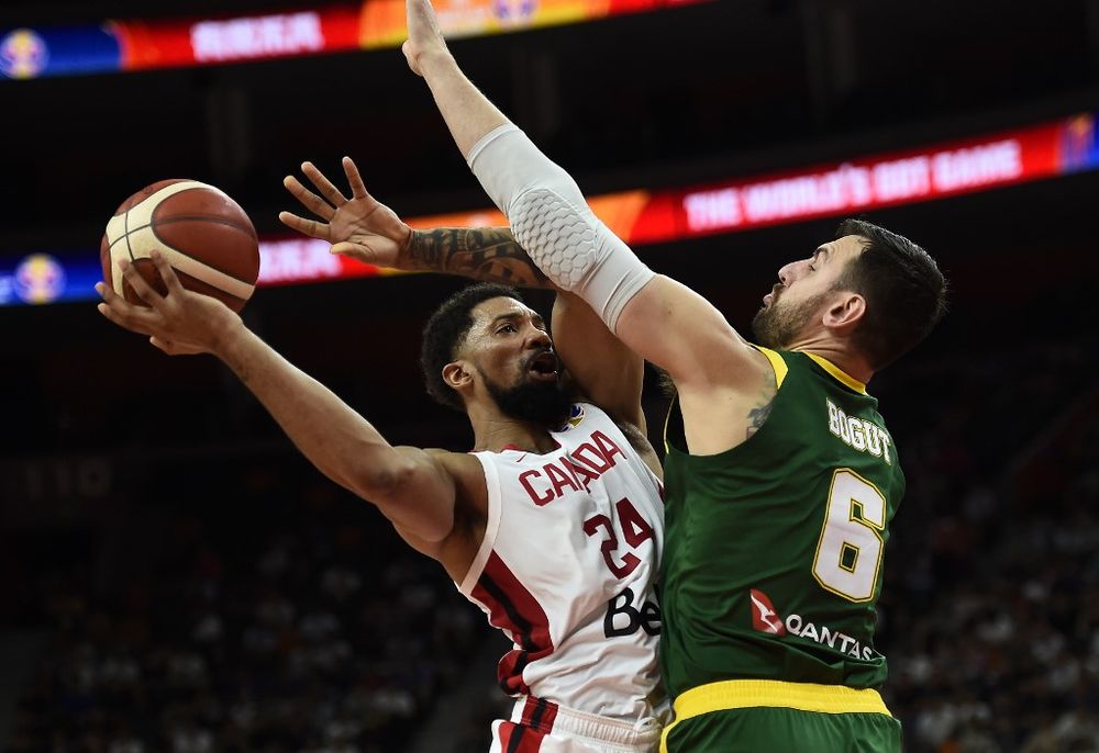 Canadau00e2u20acu2122s Khem Birch (left) tries to pass the ball through Australiau00e2u20acu2122s Andrew Bogut during the Basketball World Cup Group H game between Canada and Australia in Dongguan on September 1, 2019. u00e2u20acu201d AFP pic